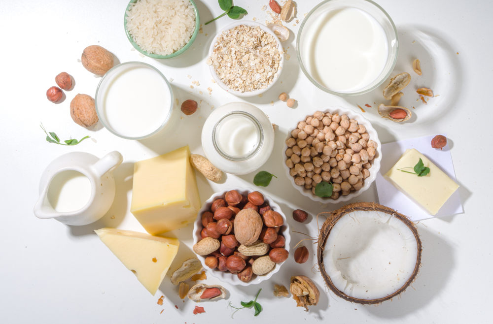A collection of milk and cheese against a white background